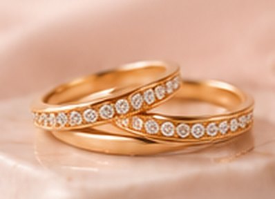 Two stacked gold rings, one set with a row of crystals